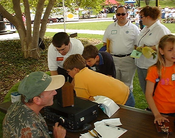 KB0HNR demonstrating APRS, KC0ACQ chatting.
